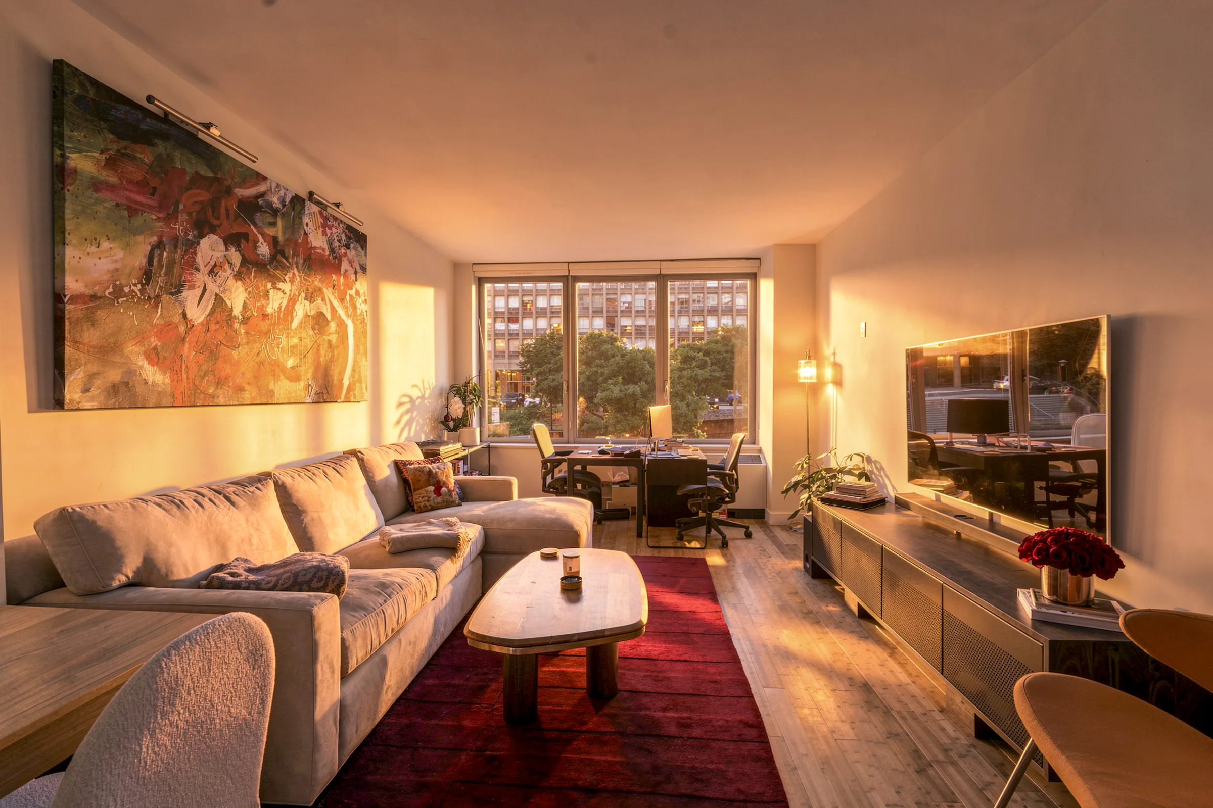 Apartment living room filled with warm golden-hour light