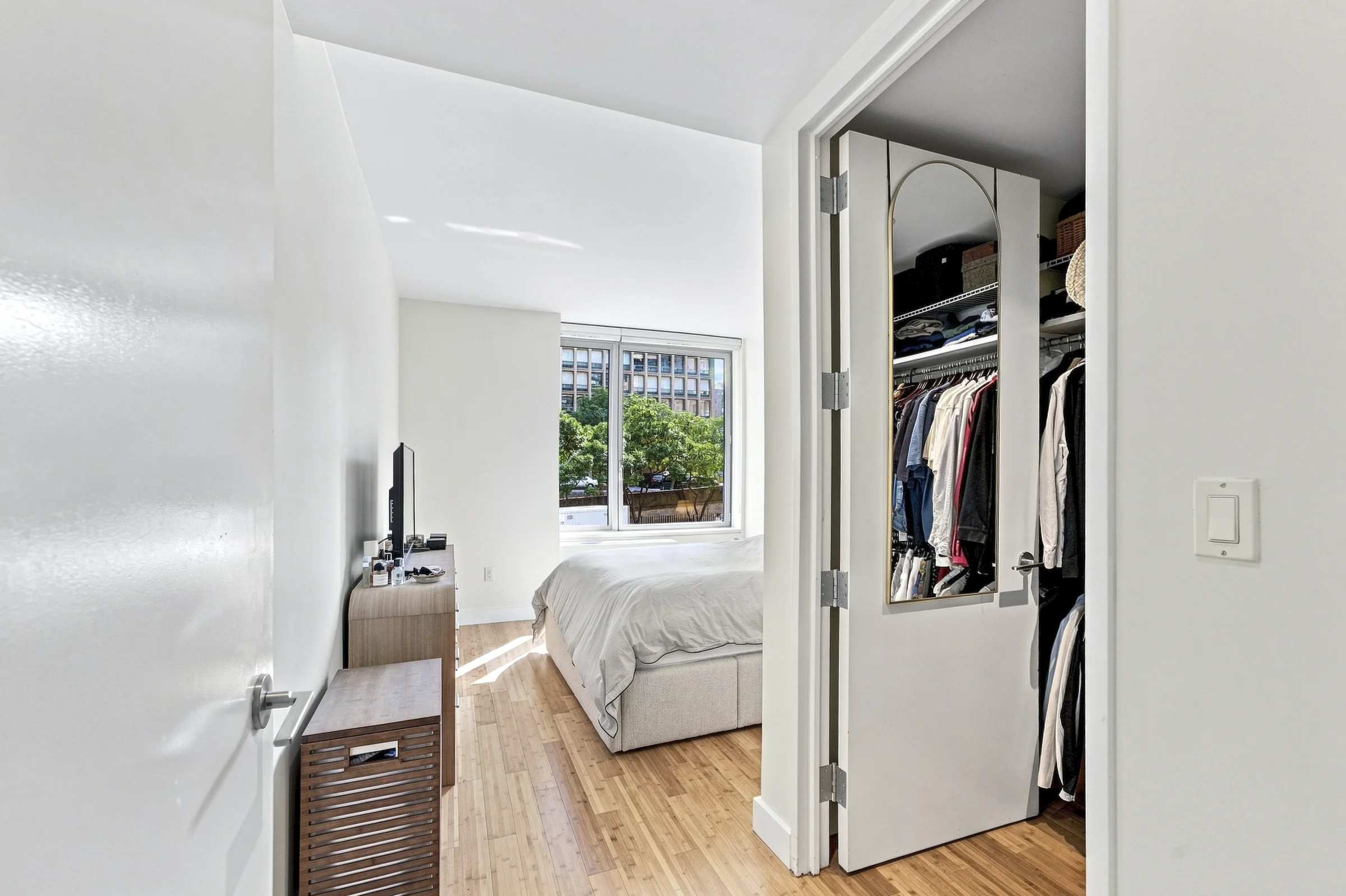 Quiet sunlit bedroom photographed with a wide composition