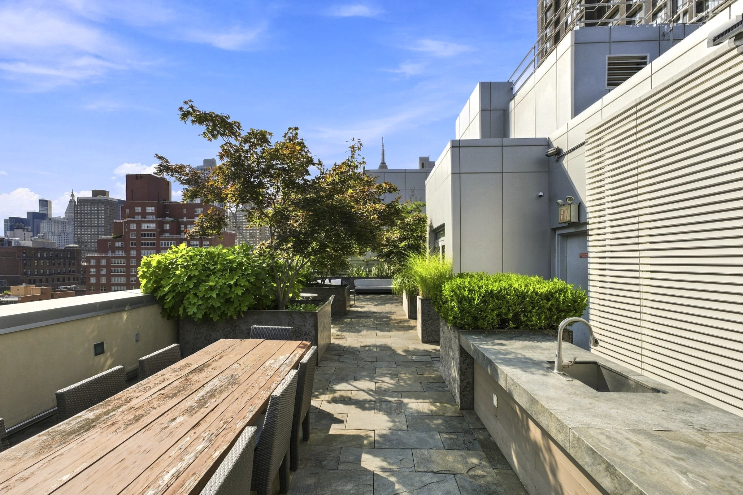 Landscaped Manhattan rooftop terrace with dining area
